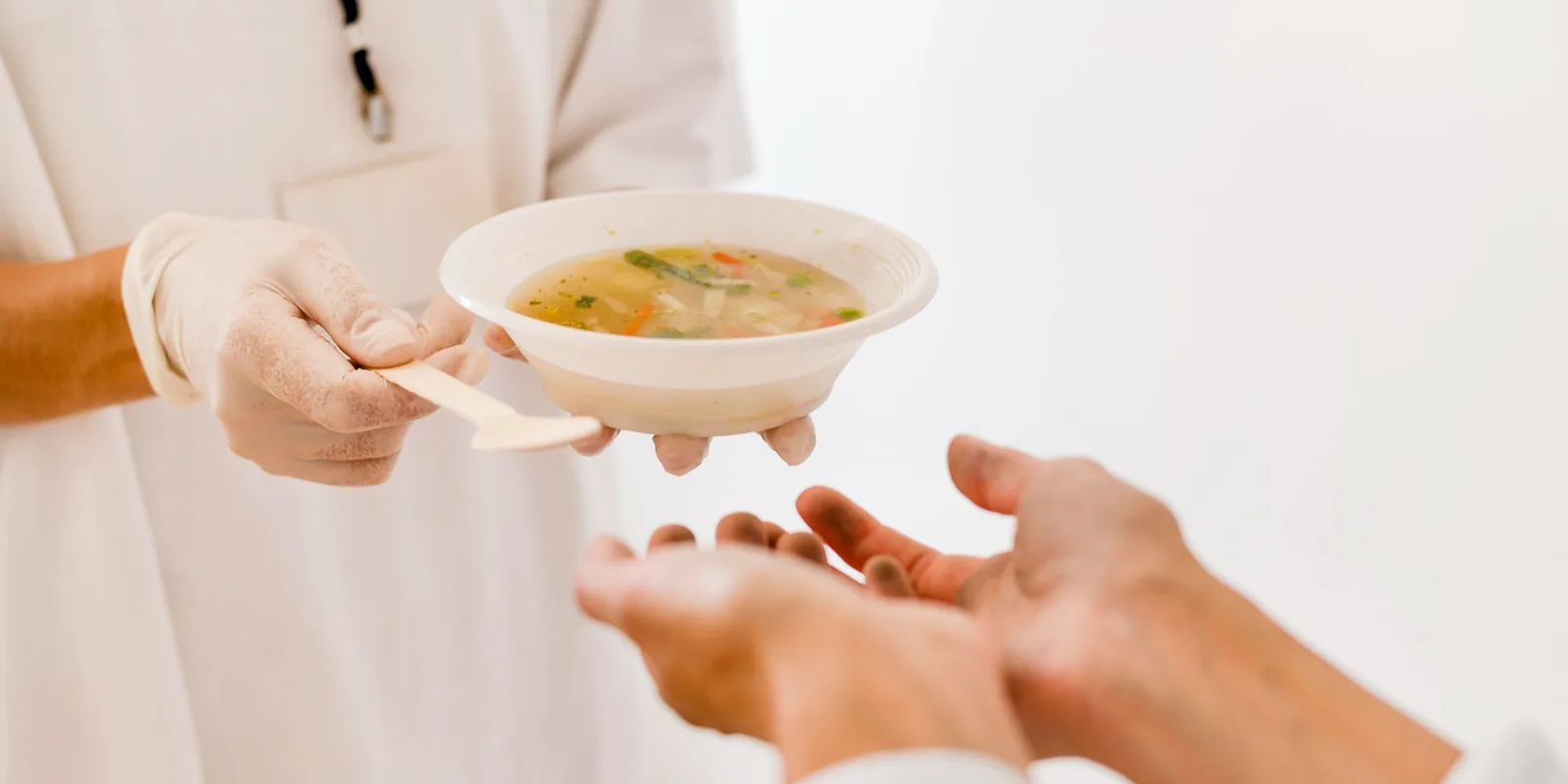 中式餐桌上，有人幫忙盛起一碗熱湯